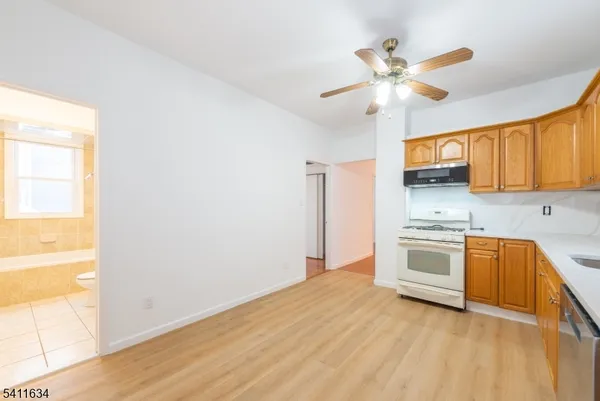 a kitchen with granite countertop a stove a sink and a window