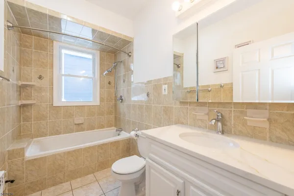 a bathroom with a sink a toilet and bathtub