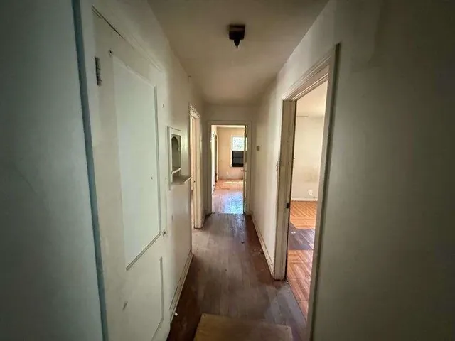 a view of hallway with wooden floor