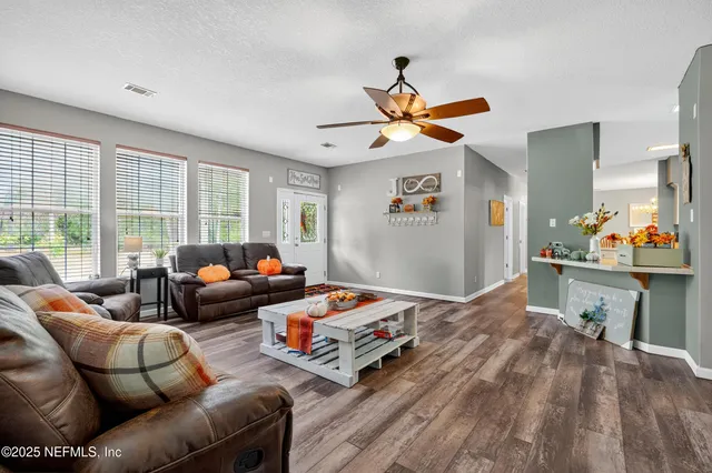 a living room with furniture and a large window