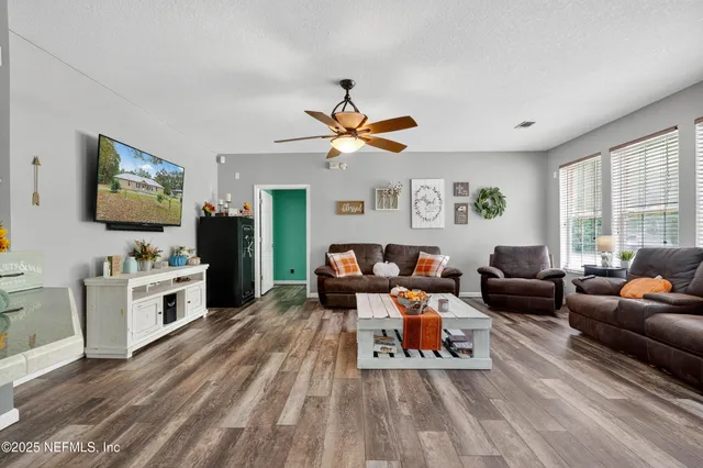 a living room with furniture and a flat screen tv