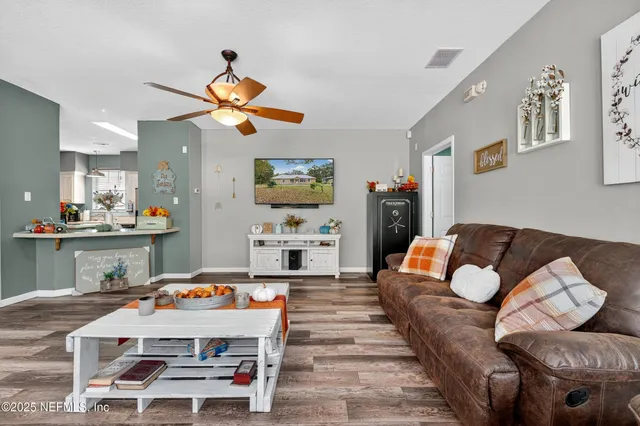 a living room with furniture and kitchen view