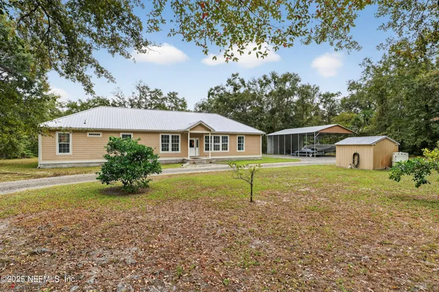 a house with green field in front of it