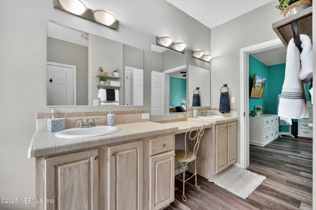 a bathroom with a double vanity sink and a mirror