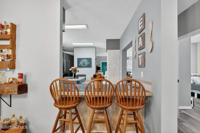 a view of a dining room with furniture and a chandelier