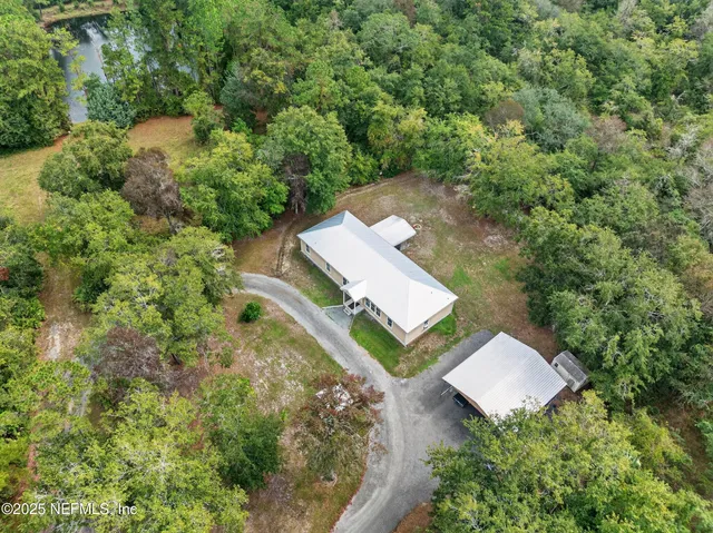 an aerial view of a house with a yard