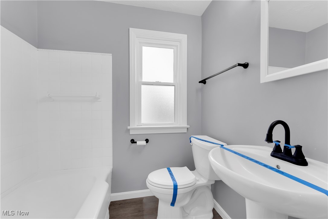 953 Whitby Road Cleveland Heights, OH 44112 - Photo 22 of 27 Full bathroom featuring shower combination and dark wood-style flooring