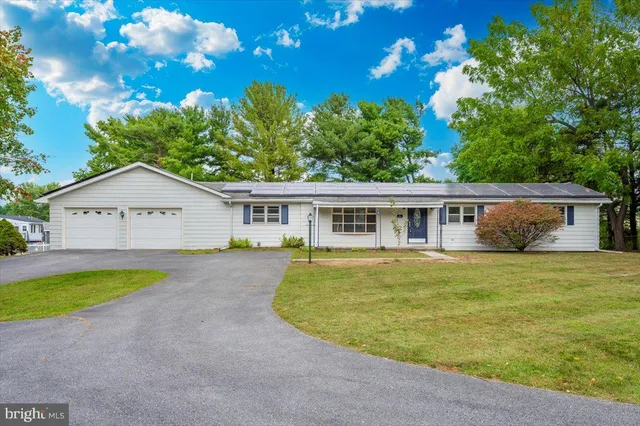 a view of a house with pool and a yard