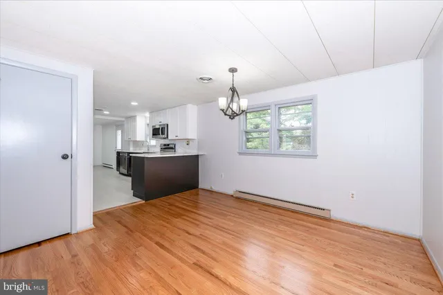 a kitchen with stainless steel appliances kitchen island granite countertop a refrigerator and a sink