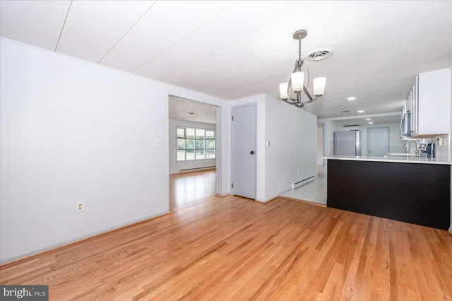 a bedroom with a bed and painting on the wall