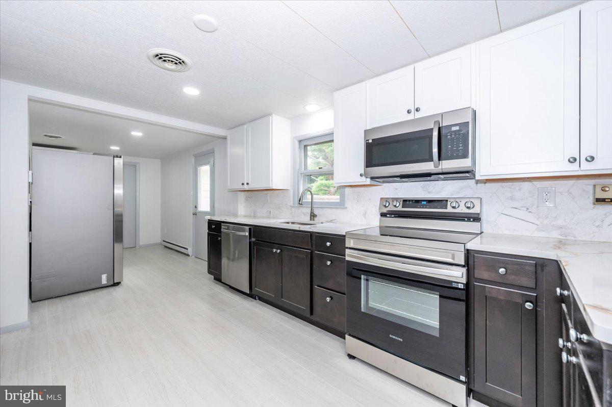 6 Schaller Lane Smithsburg, MD 21783 - Photo 18 of 51 a kitchen with stainless steel appliances granite countertop a stove a sink and a microwave