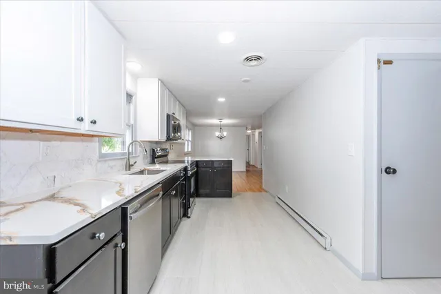 a kitchen with a sink cabinets and window