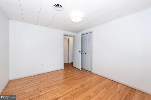 a view of a room with wooden floor