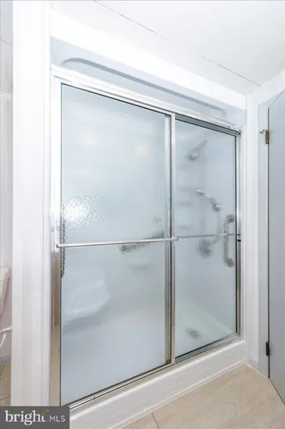 a bathroom with a glass shower door