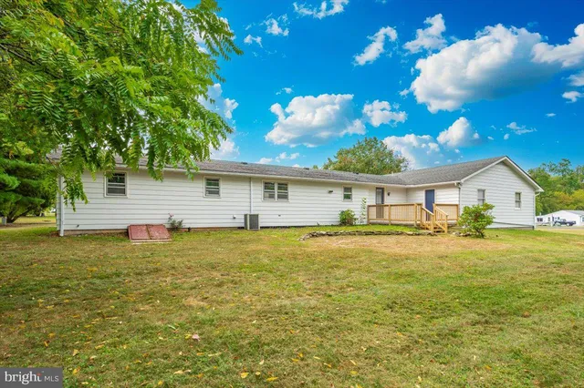 a front view of house with yard space and swimming pool