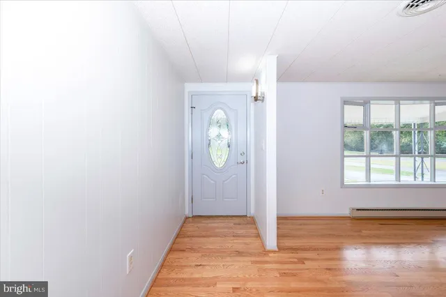 a view of a livingroom with wooden floor and window