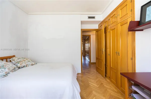 a bedroom with a bed and a mirror