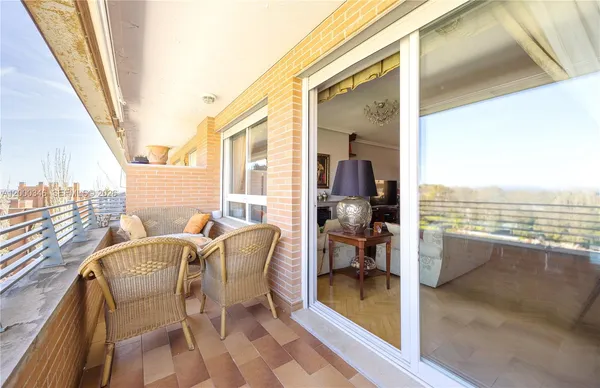 a view of a balcony with table and chairs