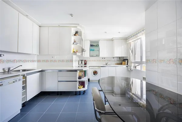 a kitchen with a sink window and cabinets