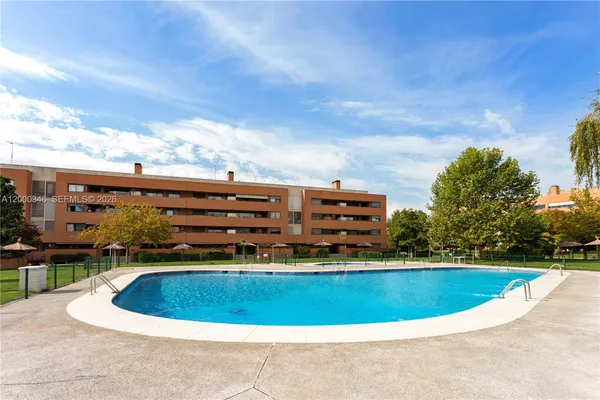a view of a swimming pool with a yard