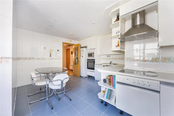 a kitchen with stainless steel appliances a stove a sink and a refrigerator