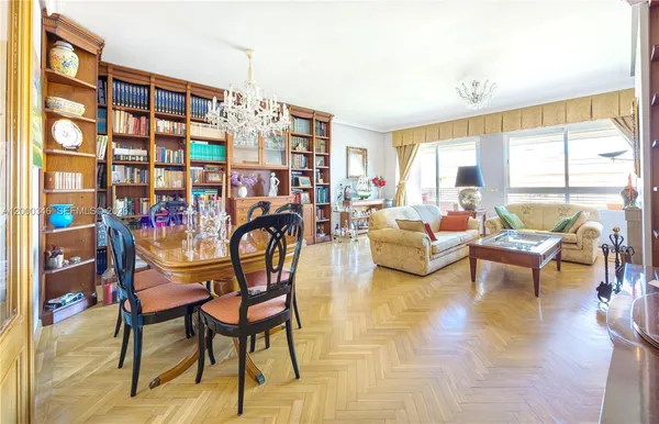 a living room with patio furniture and a large window