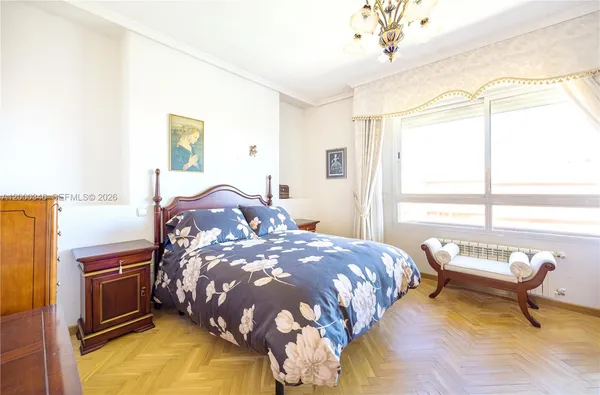 a bedroom with a bed and a chandelier