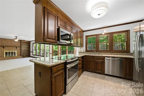 a kitchen with stainless steel appliances granite countertop a stove and a sink