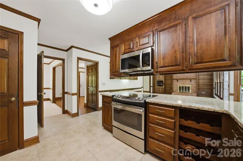a kitchen with stainless steel appliances granite countertop a stove and a microwave