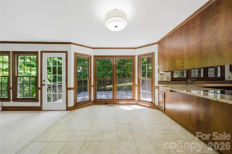 a view of a kitchen with furniture and large windows