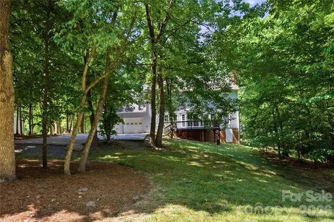 a view of a backyard with a garden and trees