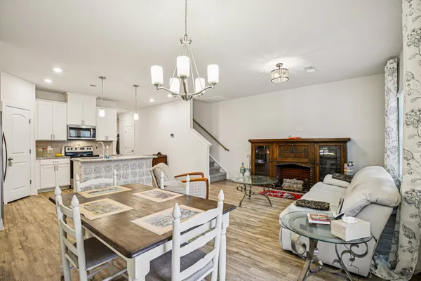 a living room with furniture and kitchen view