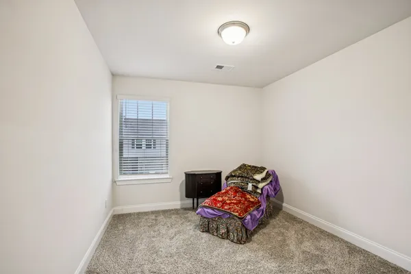 a bedroom with furniture and a window