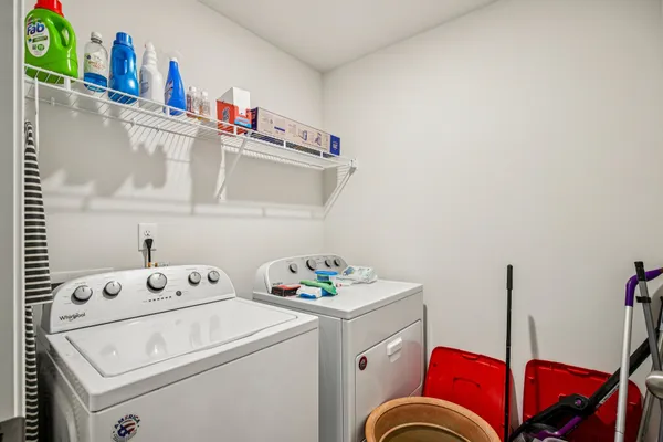 a view of walk in closet with clothes