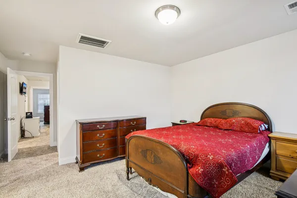 a bedroom with a bed and a desk