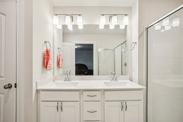 a bathroom with a double vanity sink mirror and double