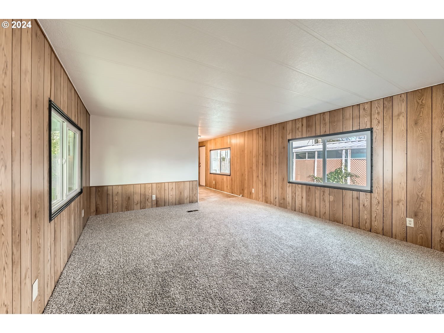7227 Southeast Flavel Street, Unit 38 Portland, OR 97206 - Photo 4 of 14 a view of an empty room with a window