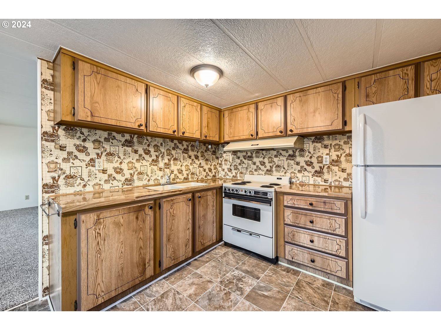 7227 Southeast Flavel Street, Unit 38 Portland, OR 97206 - Photo 6 of 14 a kitchen with granite countertop a sink stainless steel appliances and cabinets