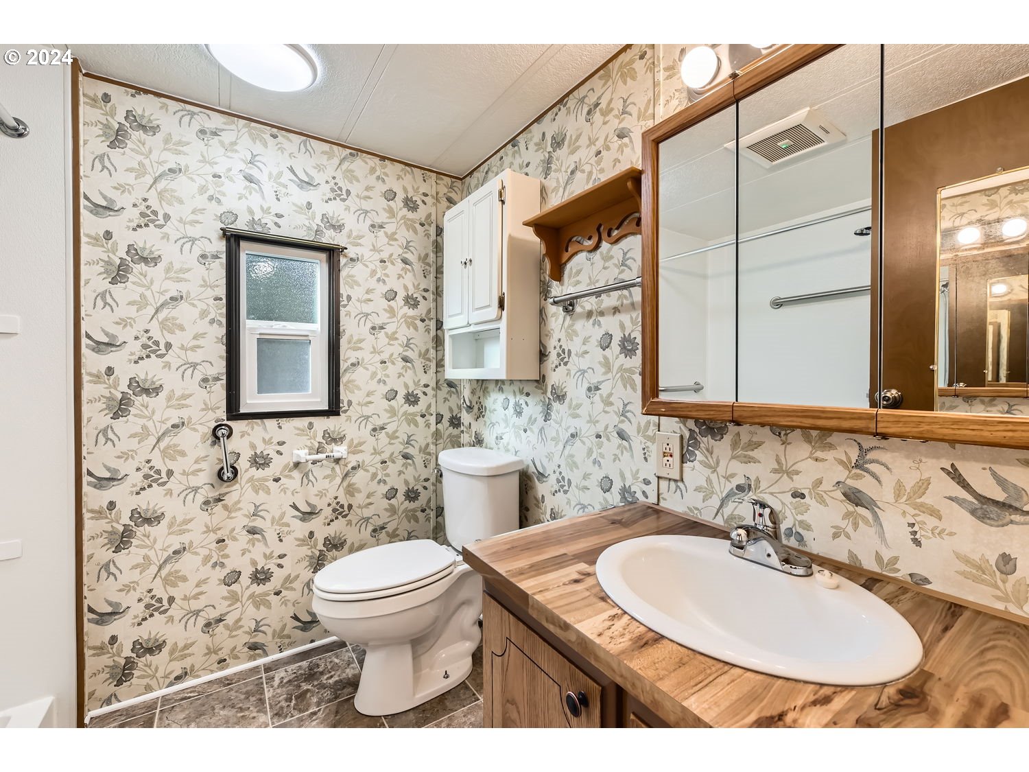 7227 Southeast Flavel Street, Unit 38 Portland, OR 97206 - Photo 9 of 14 a bathroom with a sink toilet and mirror