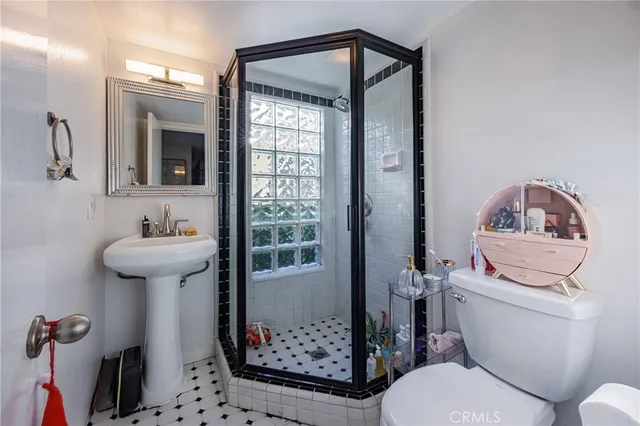 a bathroom with a sink toilet and mirror