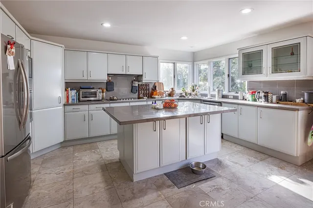 a kitchen with a sink appliances and cabinets
