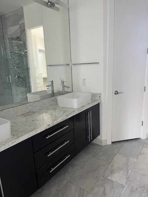 1253 Utah Street Houston, TX 77007 - Photo 7 of 14 a bathroom with a granite countertop sink and a mirror