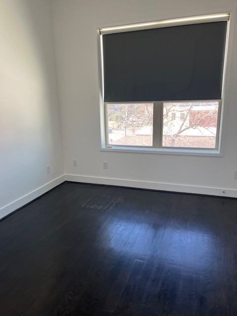 1253 Utah Street Houston, TX 77007 - Photo 10 of 14 en empty room with wooden floor and windows