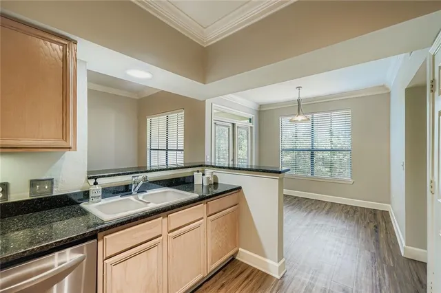 a spacious bathroom with a granite countertop sink and a large mirror