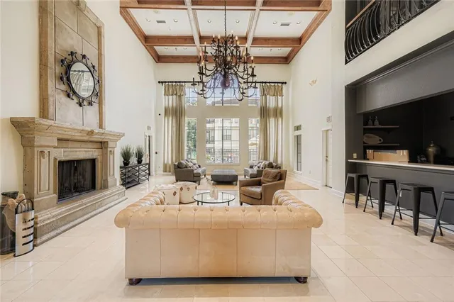 a living room with fireplace furniture and a chandelier