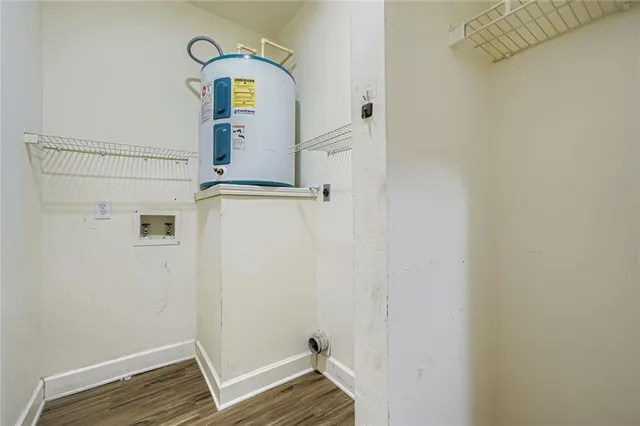 a view of storage and utility room with wooden floor