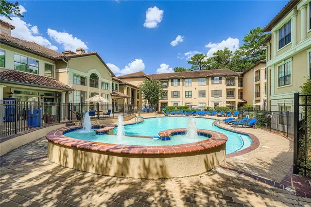 a view of a house with swimming pool and sitting area