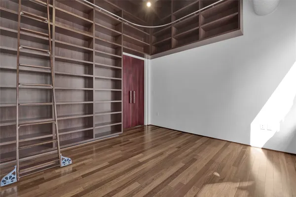 a view of a workspace with furniture and wooden floor