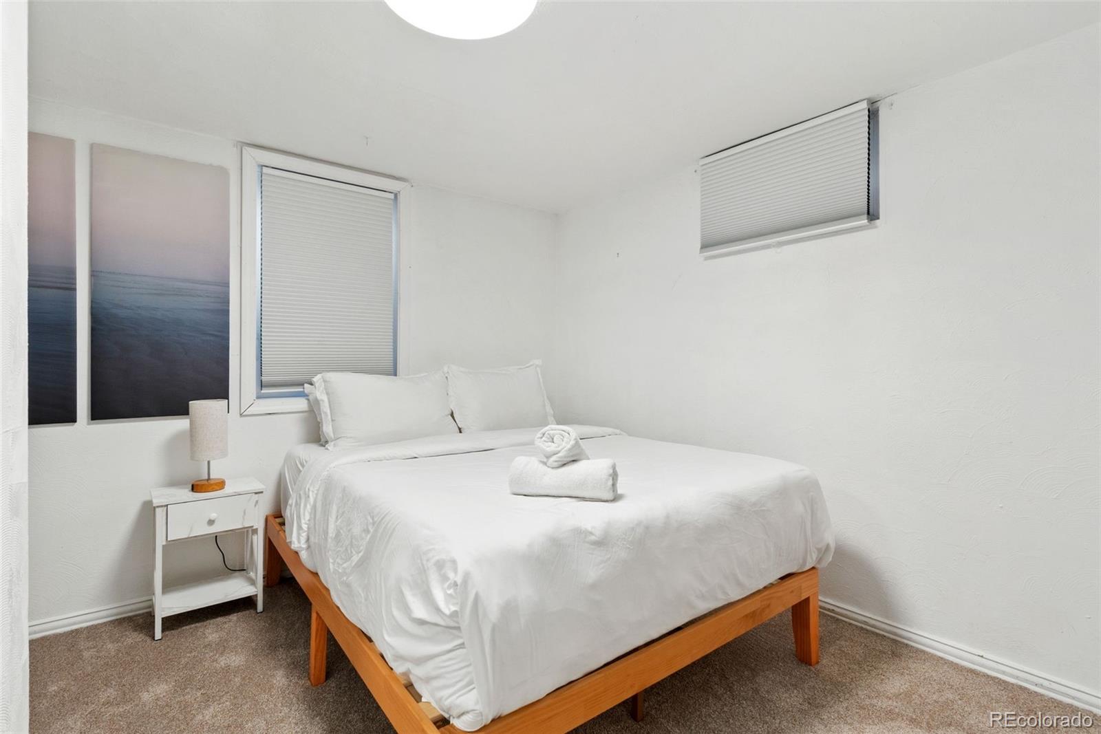 5533 Raritan Way Denver, CO 80221 - Photo 15 of 22 a bedroom with a bed and a night stand