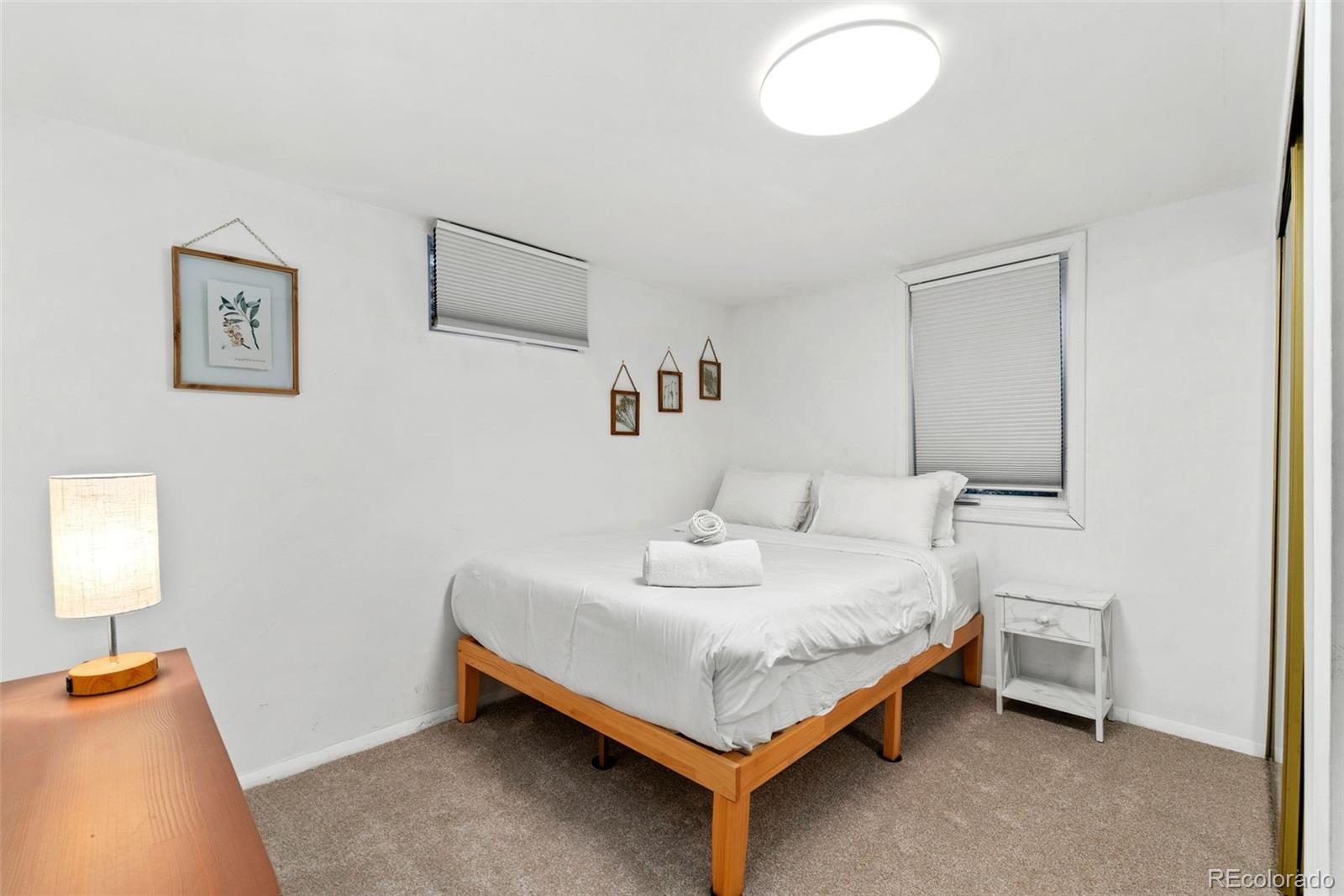 5533 Raritan Way Denver, CO 80221 - Photo 16 of 22 a bedroom with a bed and a window